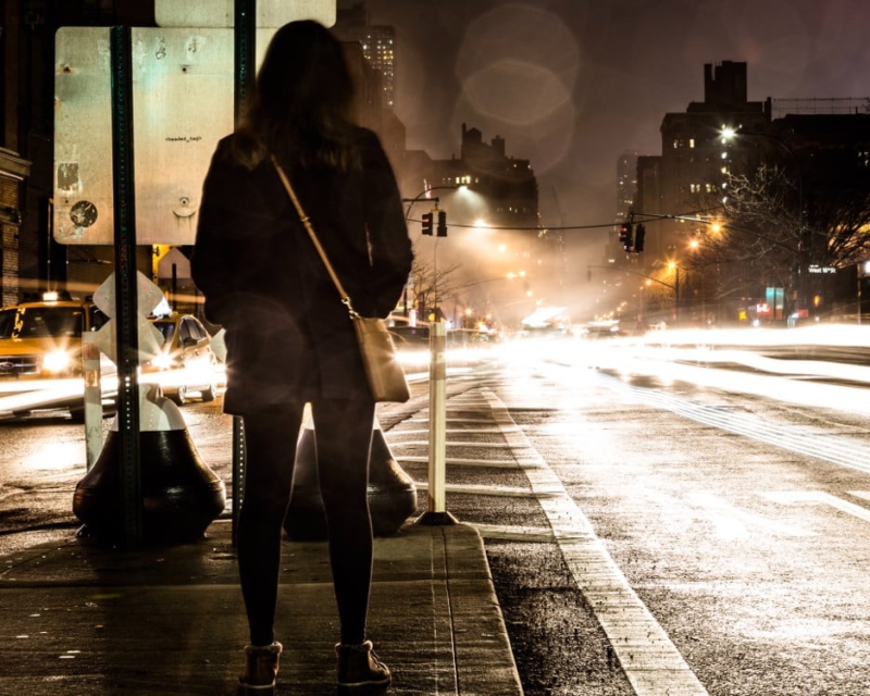 Woman in city at night