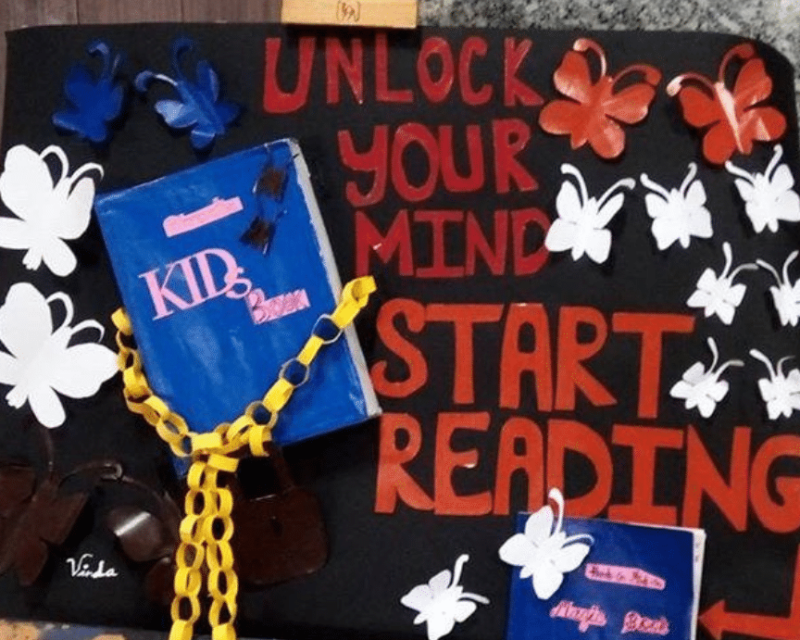 A picture of a sign outside a library that says 'unlock your mind, start reading.'