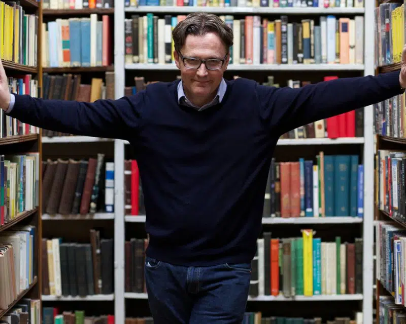 Author William Ryan in a library