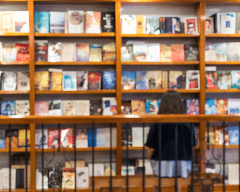 Blurred Abstract Background of Books in Bookstore. Image by Vinh Dao, Canva Pro.