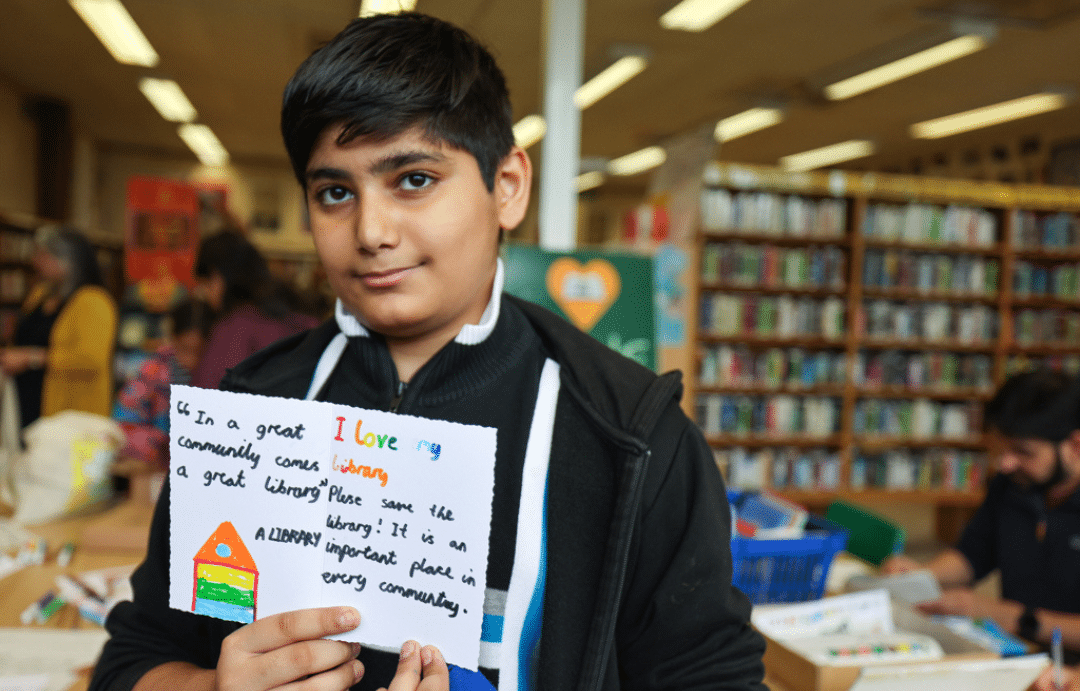 A young boy takes part in the Save Hall Green Library campaign