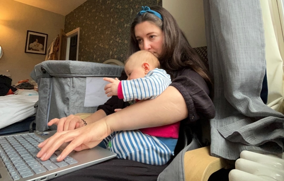 Abigail Avis editing with baby