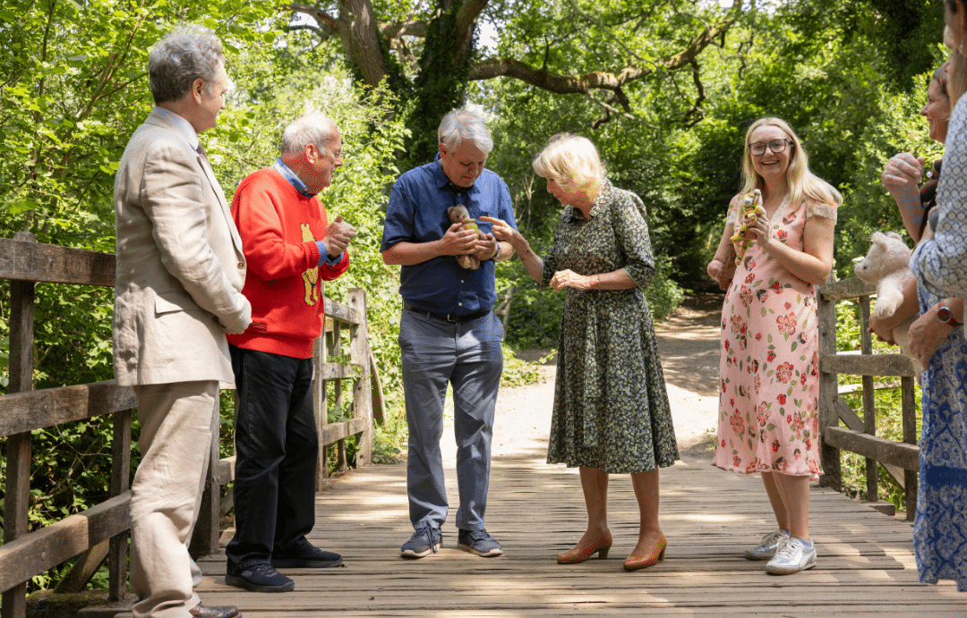 Axel Scheffler wins the first game of Pooh Sticks at Ashdown Forest, alongside Her Majesty The Queen, RLF Chief Executive Edward Kemp, Giles Brandreth, Cerrie Burnell, Sita Brahmachari and Cerrie Burnell. © Fernando Manoso.
