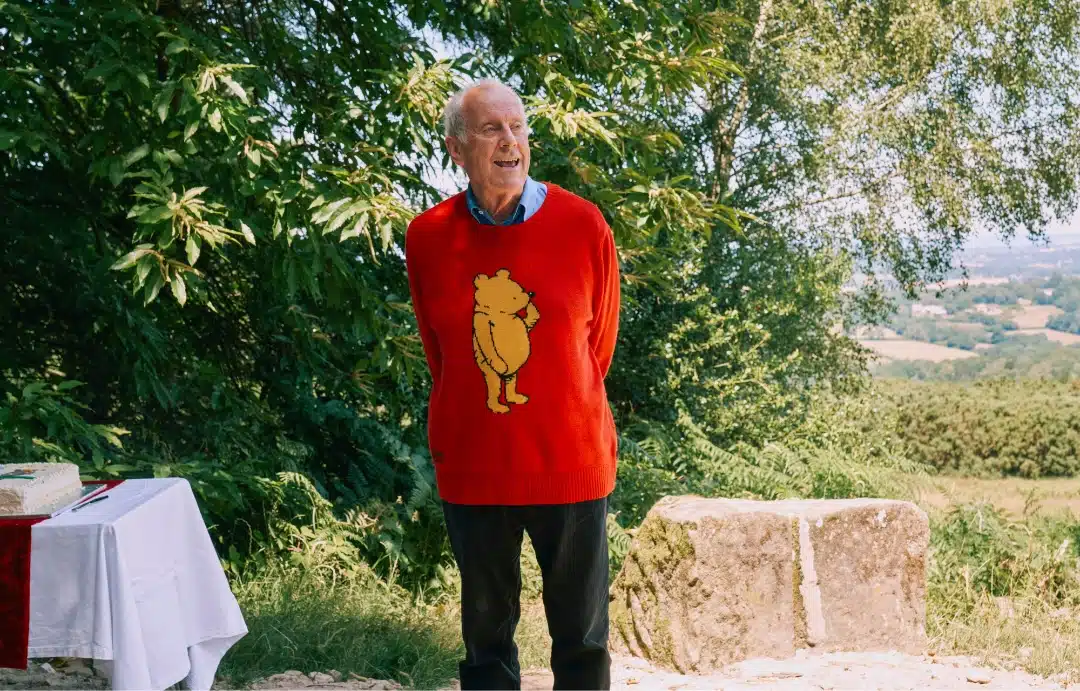 Gyles Brandreth reads from 'The House at Pooh Corner' at The Enchanted Place memorial to AA Milne and EH Shepard at Gill's Lap in Ashdown Forest