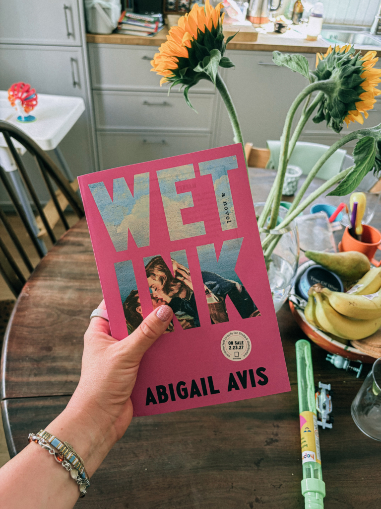 Abigail holds a copy of the American galley for Wet Ink.