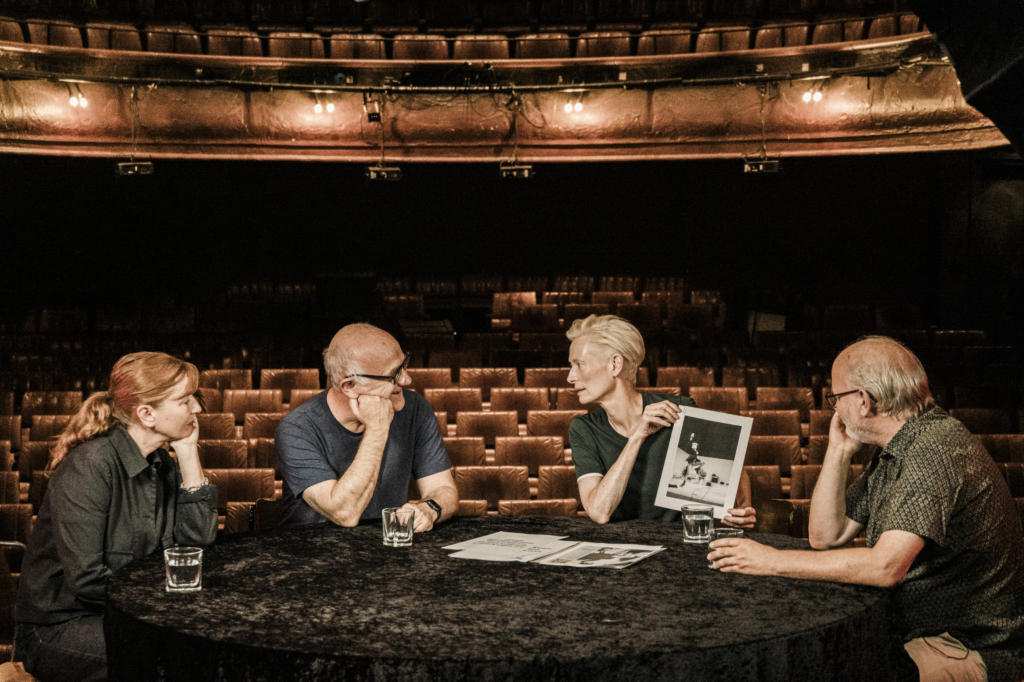 (l-r) Man to Man Stage Designer Bunny Christie, Director Stephen Unwin, Actress Tilda Swinton and Lighting Designer Ben Ormerod look back at photos from the original 1988 production at the Royal Court. © Reudiger Glatz.